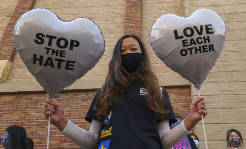 FILE - In this March 13, 2021, file photo, Chinese-Japanese American student Kara Chu, 18, holds a pair of heart balloons decorated by herself for the rally "Love Our Communities: Build Collective Power" to raise awareness of anti-Asian violence outside the Japanese American National Museum in Little Tokyo in Los Angeles. Photo: Damian Dovarganes / AP File