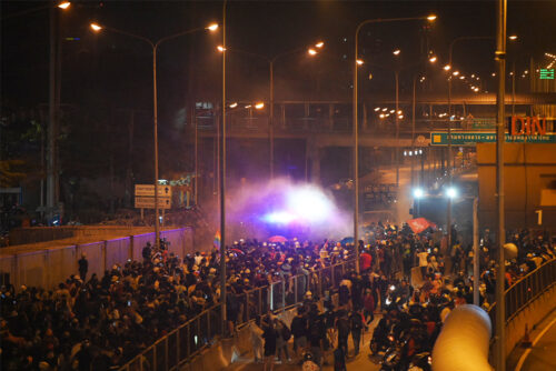 Riot police shoot water cannons at pro-democracy protesters in front of the 1st Infantry Regiment army base on Feb. 28, 2021.