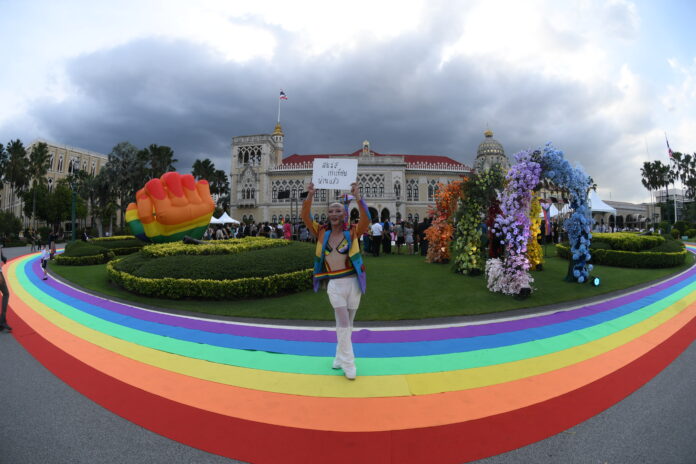 A supporter holds a placard during a celebration of the approval of same-sex marriage bill at the Government House on June 18, 2024.